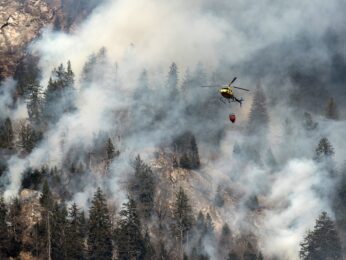 BRAND, GRAUBUENDEN, MISOX, A fire fighting helicopter discharges water over the forest fires near Mesocco in Southern Switzerland, Wednesday, December 28, 2016. (KEYSTONE/Ti-Press/Gabriele Putzu)
